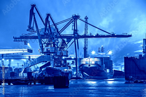 Container ship in port at night - Shipping concept.