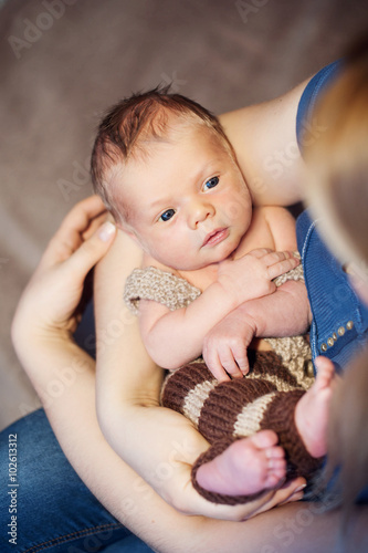 Infant. A woman holds in her arms her newborn baby photo