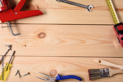 Carpentry, construction hardware tools on wooden planks. Top view, copy space.