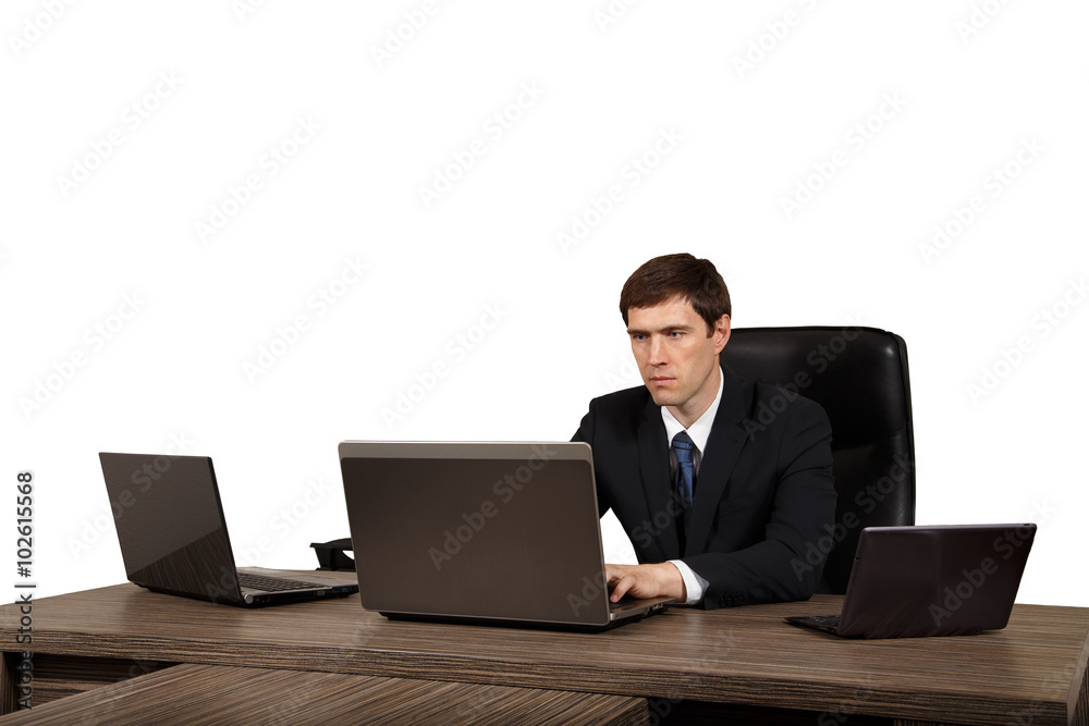 Businessman at his desk with a laptop, isolated on white background Businessman at his desk with a laptop, isolated on white background