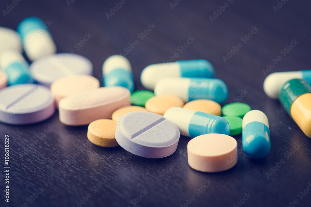Pharmacy background on a black table. Tablets on a black background. Pills. Medicine and healthy. Close up of capsules. Pharmacy background on a black table. Tablets on a black background. Pills. Medicine and healthy. Close up of capsules.