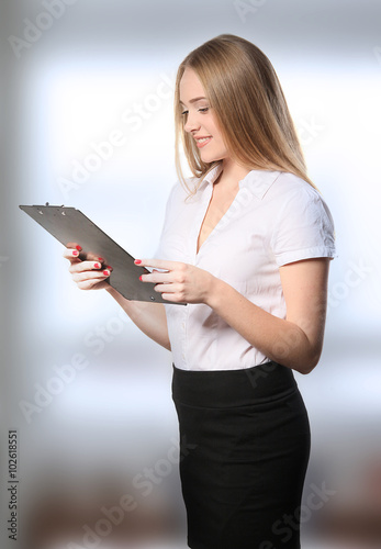 Business woman with clipboard isolated on white