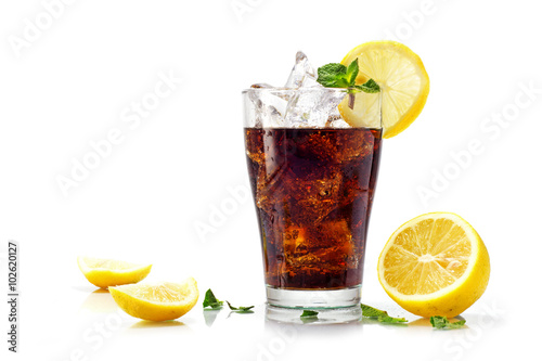 glass of cola or coke with ice cubes, slices of lemon and pepper