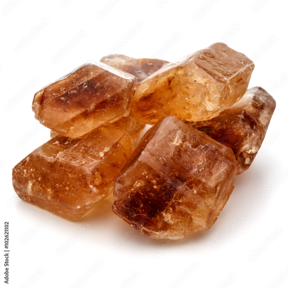Brown caramelized lump cane sugar cube isolated on white backgro Brown caramelized lump cane sugar cube isolated on white backgro