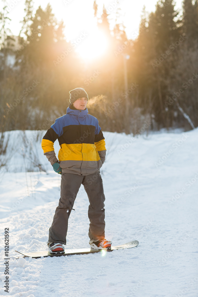 snowboarder walking in a winter day