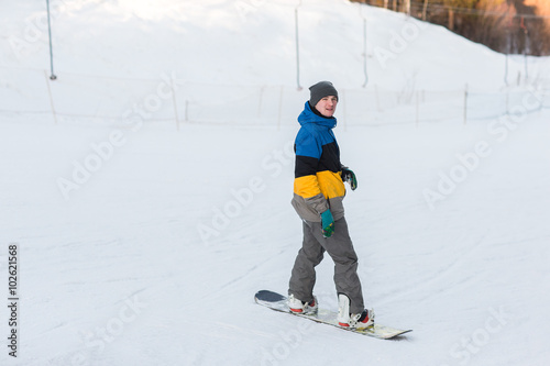 snowboarder walking in a winter day