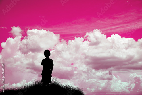 A lonely boy looking at pink sky Silhouette