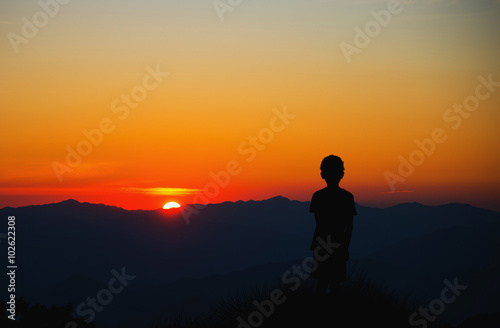 A lonely boy looking at sunset and think....
