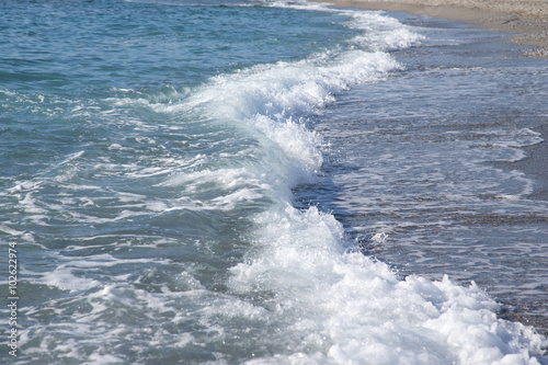 Wave on the pebble coast of sea. Selective focus © strannik_fox