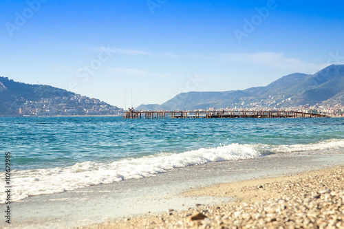 Wave on the beach and beautiful view to ancient fortress on the