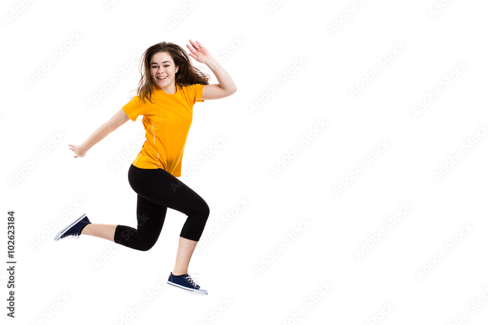 Teenage girl jumping on white background 
