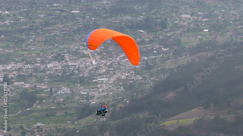 Experience the thrill of a solo paraglide flight over Patate City in Central Ecuador's Tungurahua Province. photo