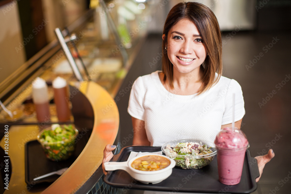 Cute woman with a tray of healthy food