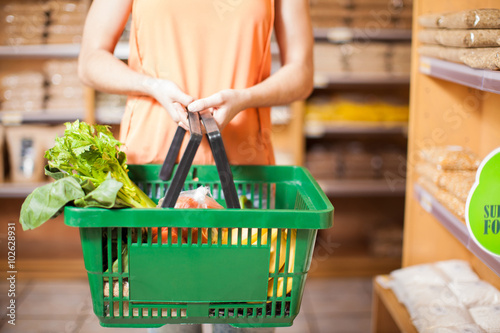 Woman with some groceries in a basket