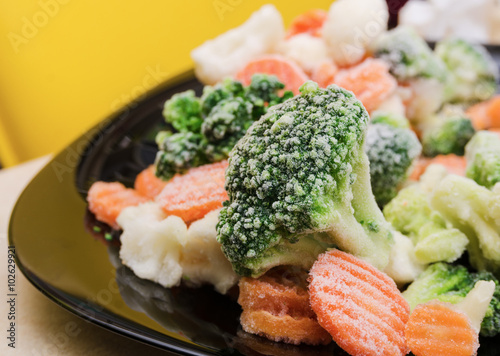 broccoli, carrots, frozen vegetables on a plate close-up