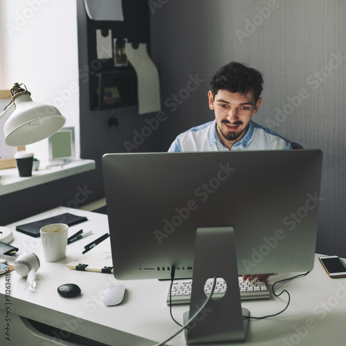 Young graphic designer working in office