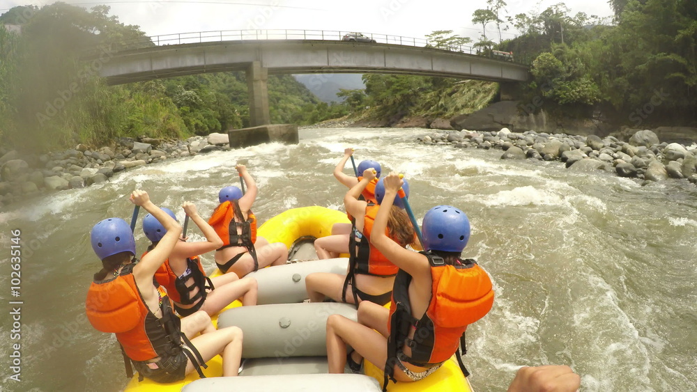 Experience the thrill of white water rafting as a dynamic team of young adult women expertly navigate the rapids,their commanding voices echoing through the exhilarating adventure.