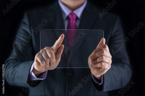 Business man holding blank futuristic transparent mobile, smart