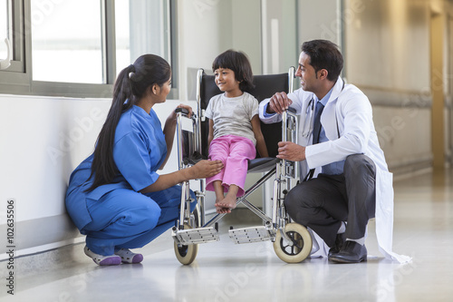 Nurse Doctor and Female Girl Child Hospital Patient in Wheelchai © spotmatikphoto