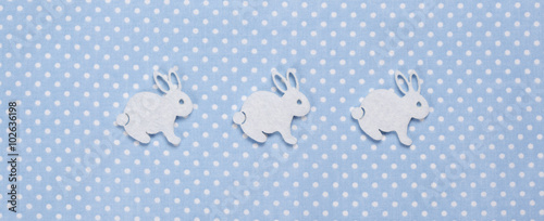 Felt easter bunnies on blue spotted background