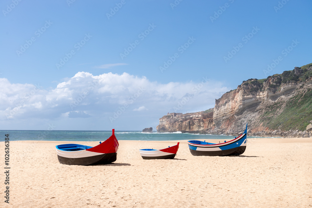Main beach in Nazare with Traditional colorful boats