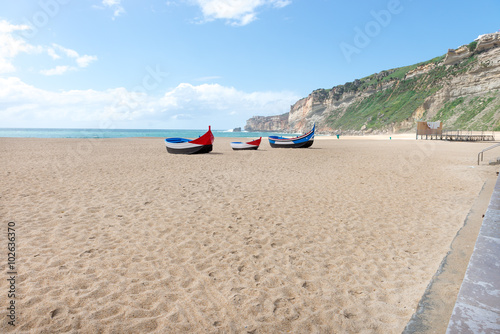 Main beach in Nazare with Traditional colorful boats