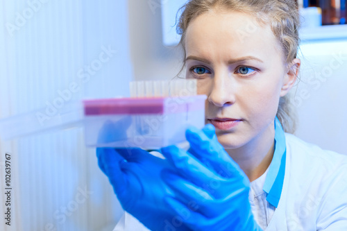 Closeup of woman scientist chemist with test tubes in modern laboratory