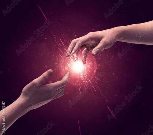 Touching hands light up sparkle in space