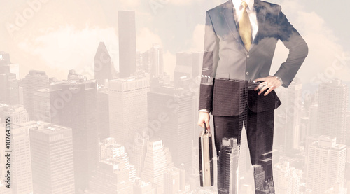 Handsome business man with overlay cityscape