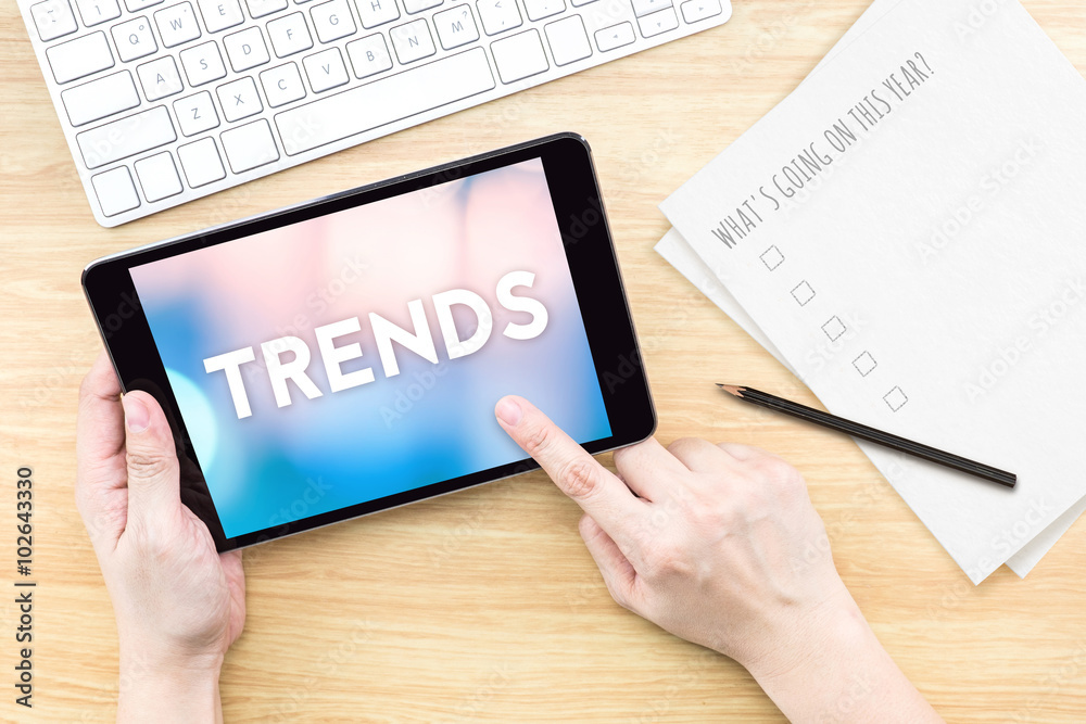 Finger touch screen with Trends word with keyboard and paper on Finger touch screen with Trends word with keyboard and paper on
