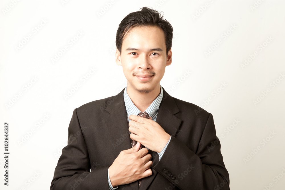 business man tighten his tie with strong friendly and confident face. business man tighten his tie with strong friendly and confident face.