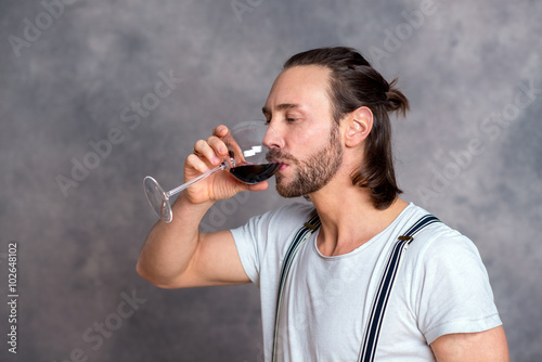 young man drinking red wine