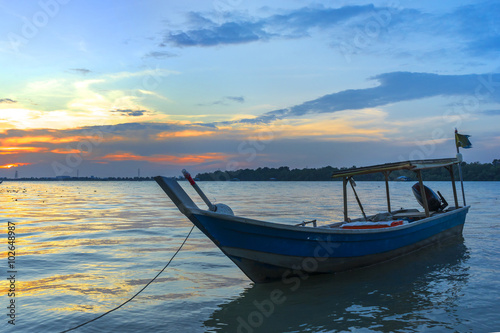 Wooden fisherman boat with sunset background