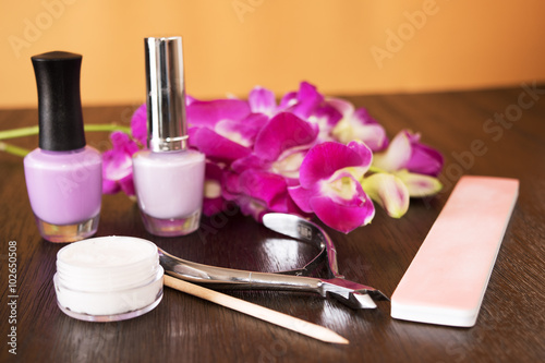 Manicure set on a wooden table with Orchid