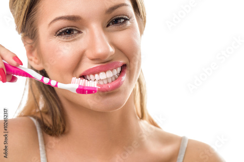 Smiling woman during brushing teeth