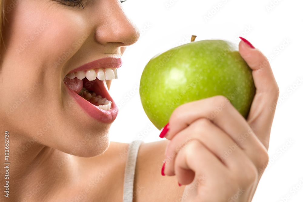 woman biting green apple with heathy teeth woman biting green apple with heathy teeth