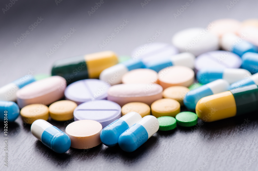Pharmacy background on a black table. Tablets on a black background. Pills. Medicine and healthy. Close up of capsules. Differend kind of pills Pharmacy background on a black table. Tablets on a black background. Pills. Medicine and healthy. Close up of capsules. Differend kind of pills