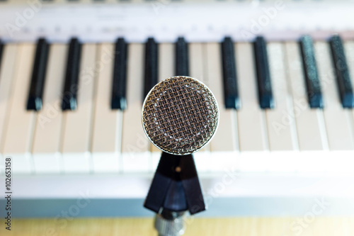 Fotografie Silver microphone on background keys synthesizer