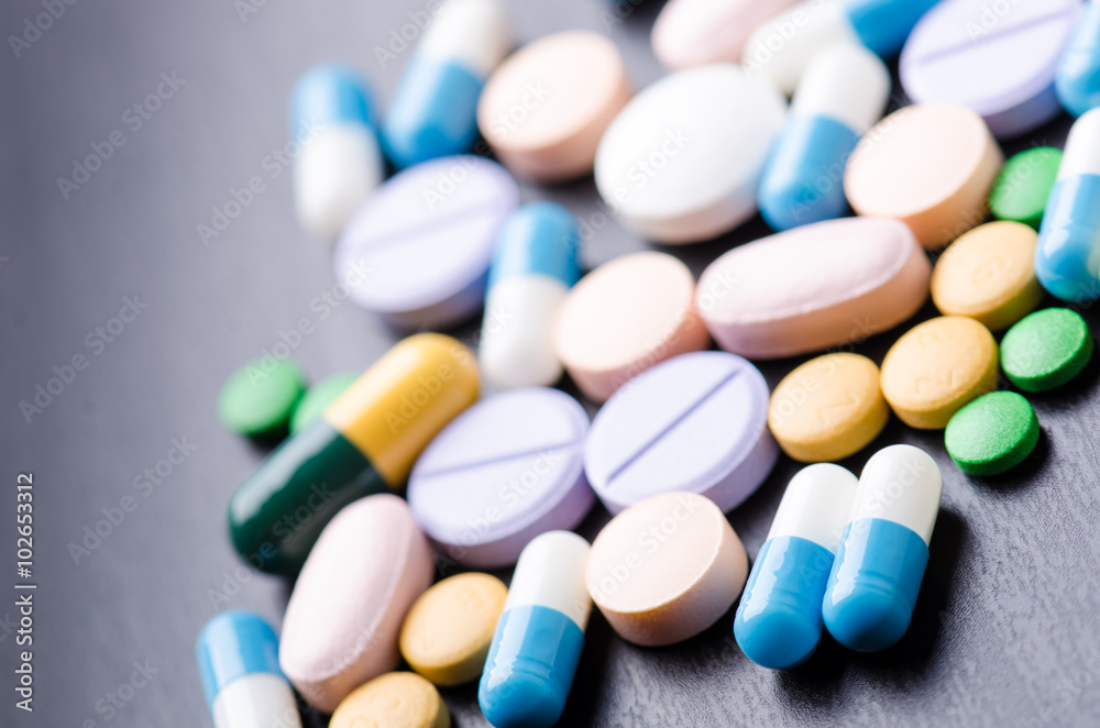 Pharmacy background on a black table. Tablets on a black background. Pills. Medicine and healthy. Close up of capsules. Differend kind of pills