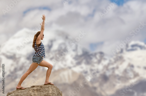Woman doing yoga with Himayalayan mountain background.