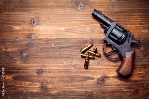 Vintage pistols on wooden background