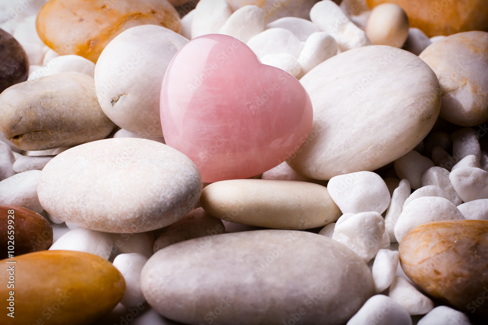 Pink heart stone on the spa stone background. Pink heart stone on the spa stone background.