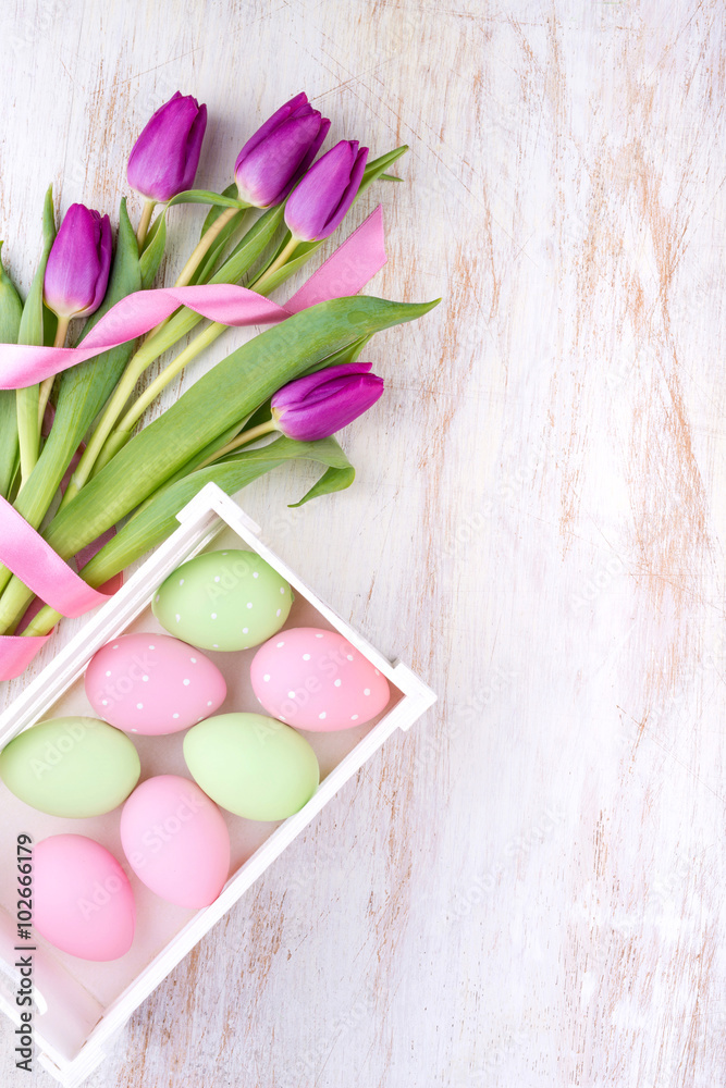 easter eggs and flowers over white wooden table easter eggs and flowers over white wooden table