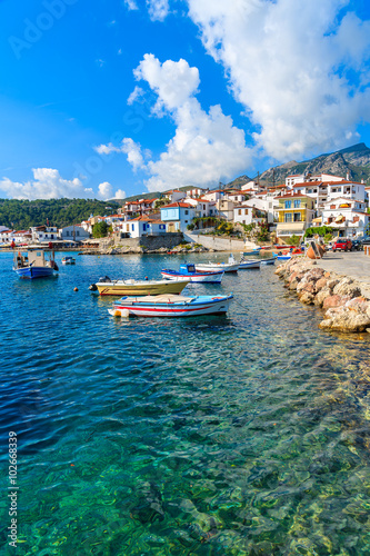 Fishing boats in Kokkari port with colourful Greek houses, Samos island, Greece © pkazmierczak