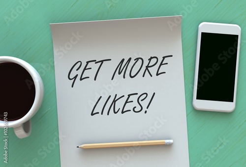 Get More Likes, message on paper, smart phone and coffee on table photo
