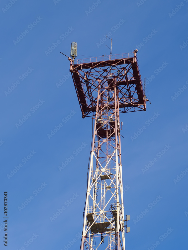 top part of communication tower with antennas closeup on blue sky
top part of communication tower with antennas closeup on blue sky