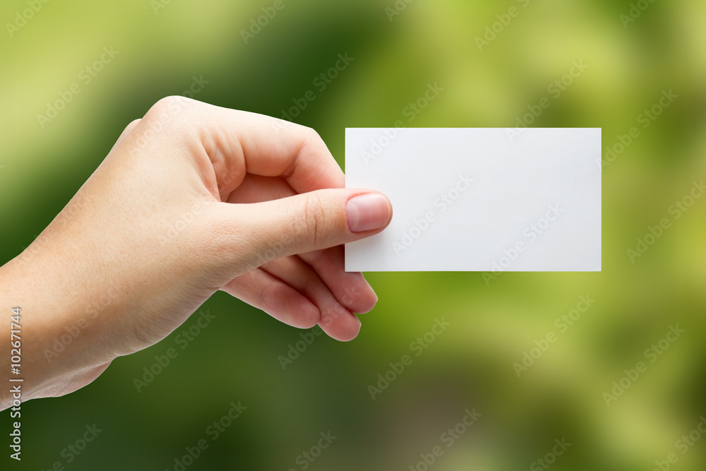 Hands holding a white business visit card, gift, ticket, pass, p Hands holding a white business visit card, gift, ticket, pass, p