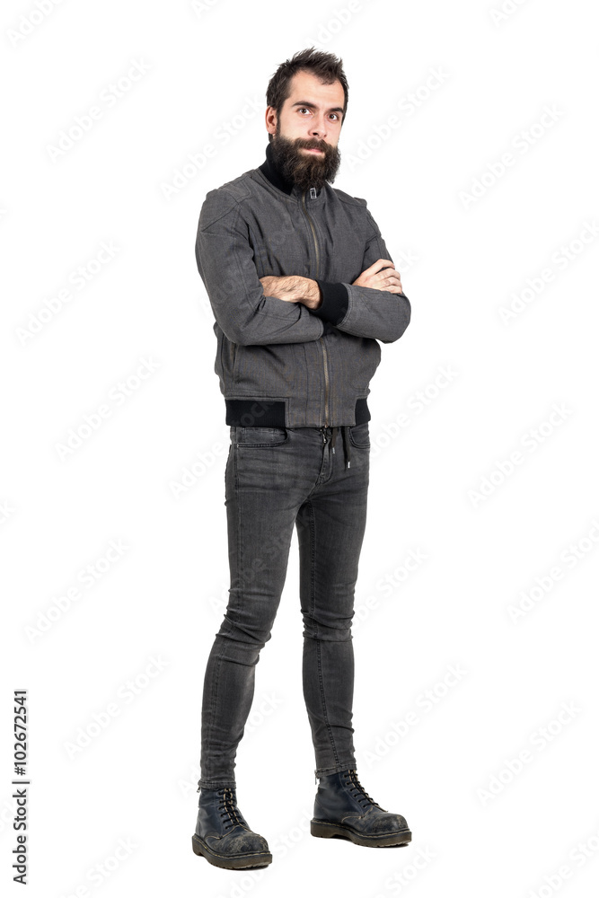 Confident tough punker in military boots and gray jacket with crossed arms looking at camera. Full body length portrait isolated over white studio background. Confident tough punker in military boots and gray jacket with crossed arms looking at camera. Full body length portrait isolated over white studio background.