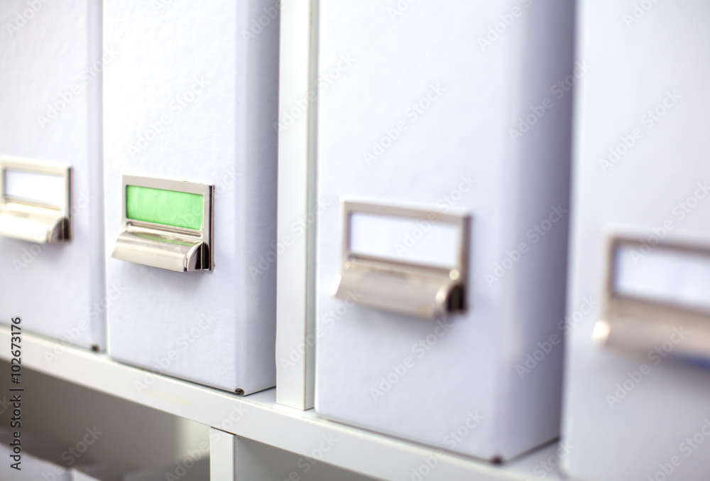 File folders, standing on shelves in the background File folders, standing on shelves in the background