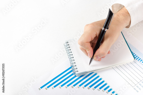 Businessman counting losses and profit working with statistics, analyzing financial the results on white background. Copy space